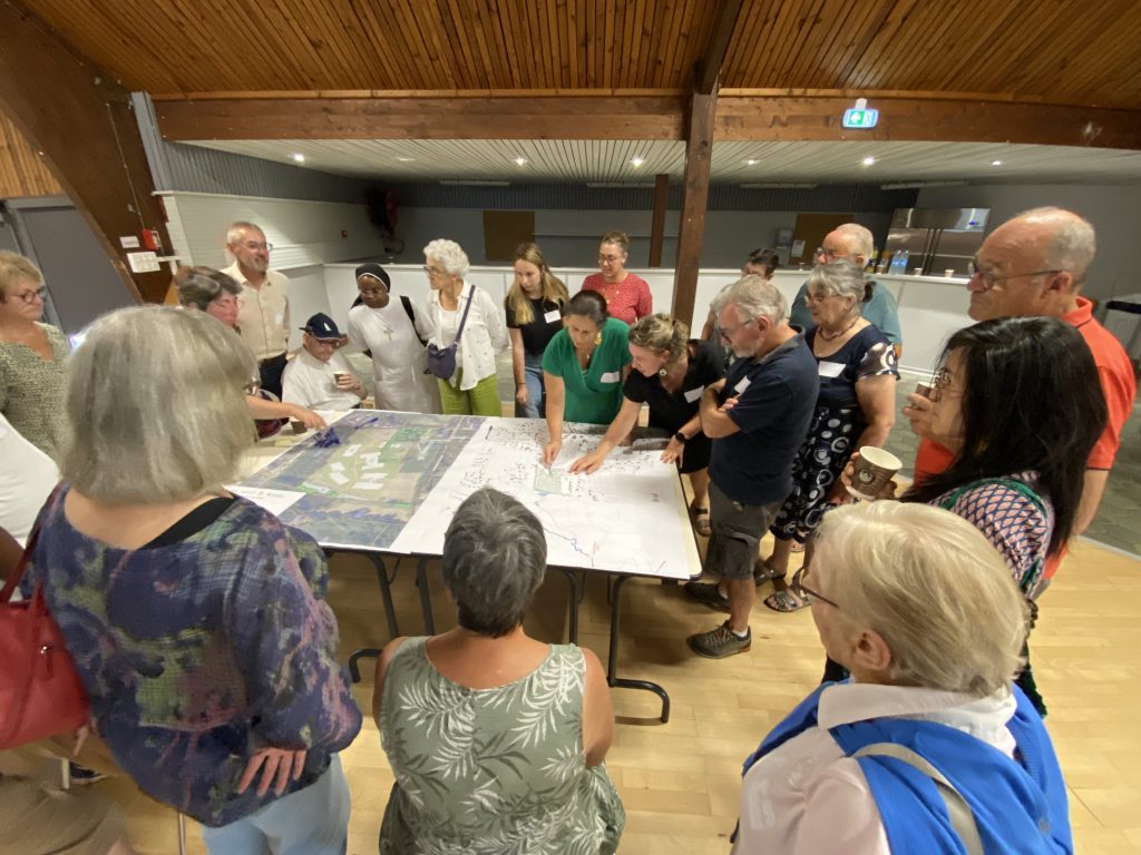 Participants réunis autour des plans du projet des Maisons Alzheimer lors de l'atelier de co-construction à Quessoy